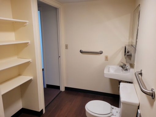 a small bathroom with a toilet sink and shelves