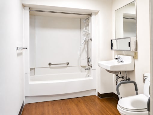 A white bathroom with a toilet, sink, and bathtub.