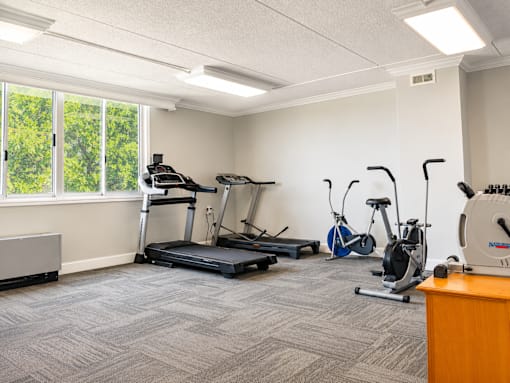 A room with exercise equipment and a window.