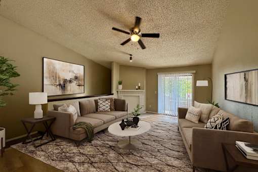 A living room with a brown couch, a white coffee table, and a ceiling fan.