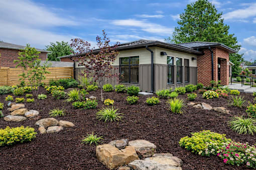 A house with a garden in front of it.