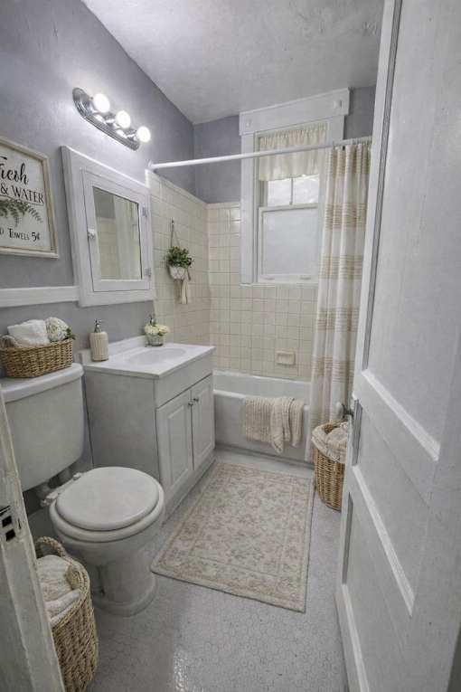 A bathroom with a toilet, sink, and shower.