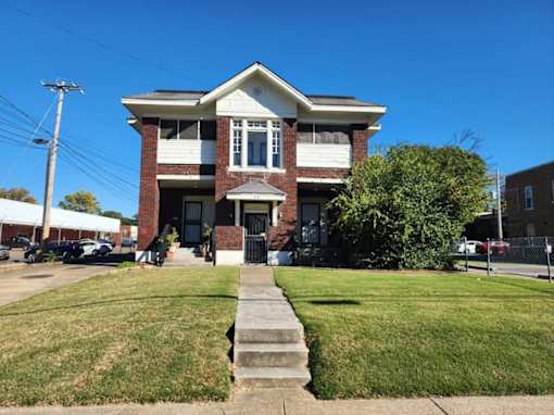 A house with a white front porch and a black door.