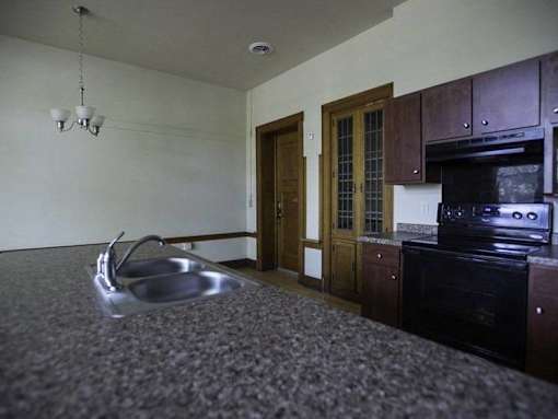 A kitchen with a black oven and a sink.