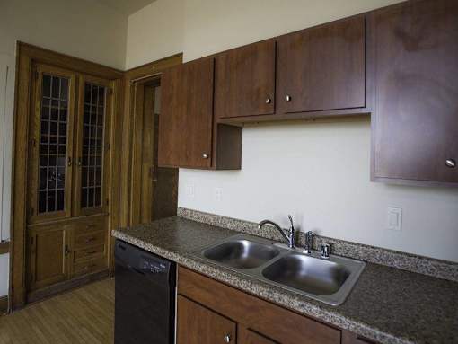 A kitchen with a sink and a dishwasher.