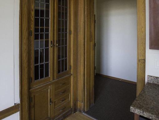 A brown wooden door with glass panels and a handle.