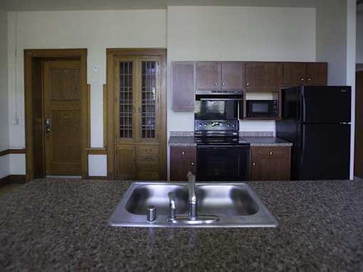 A kitchen with a sink and a refrigerator.