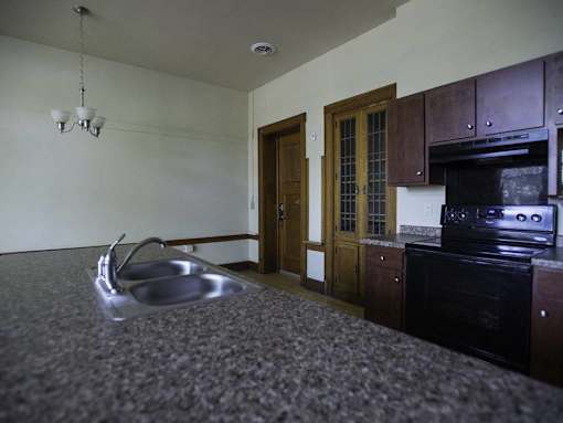 A kitchen with a sink and an oven.