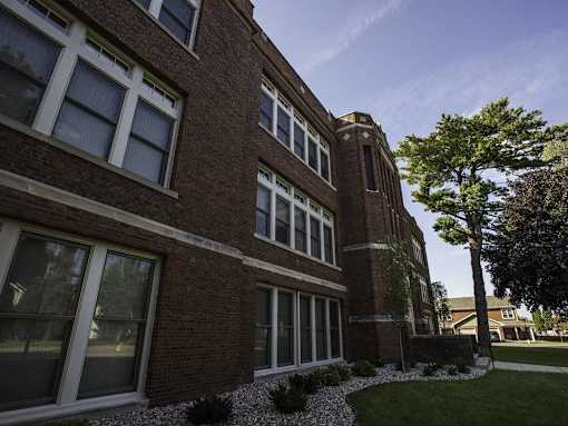 A red brick building with white trim and windows.