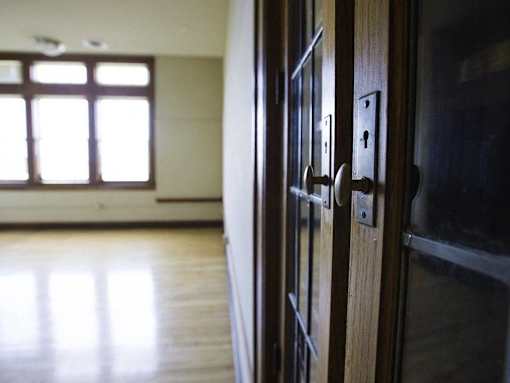 A brown door with a handle and a lock.