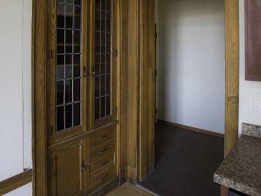 A brown wooden door with glass panels and a handle.
