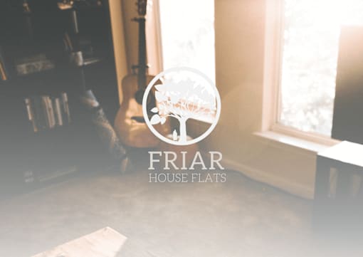 A room with a guitar and a window with the logo friar house flats.