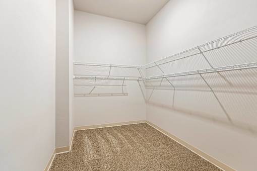 Empty room with white walls and shelves.