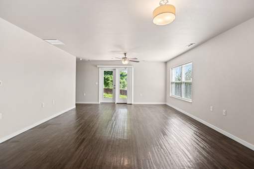 A room with wooden flooring and a ceiling fan.