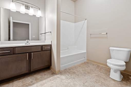 A white toilet sits in a bathroom next to a walk-in shower.