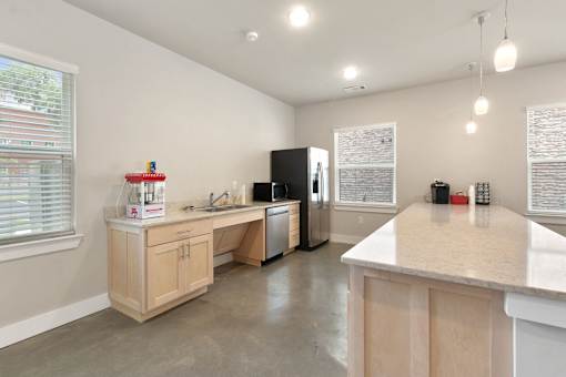 A kitchen with a white counter top and wooden cabinets.