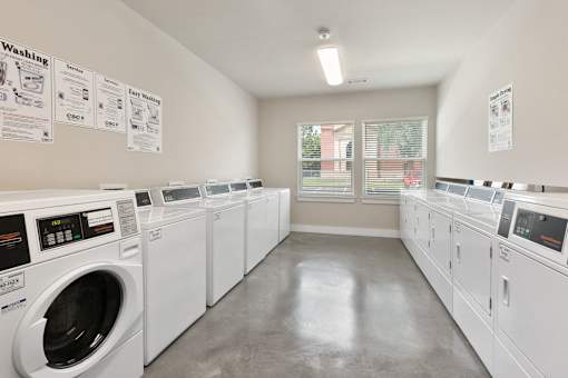 A laundromat with rows of washers and dryers.