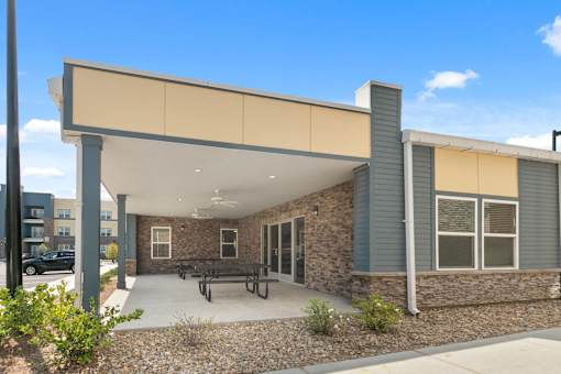 A modern building with a covered outdoor seating area.