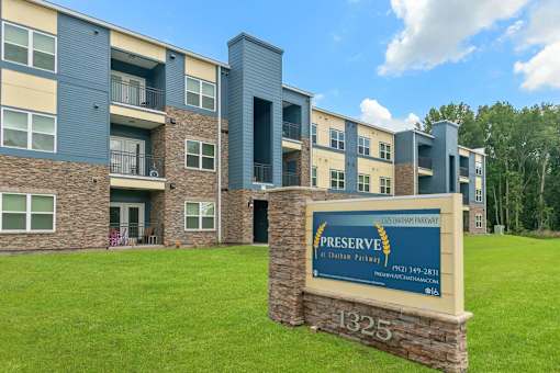 A sign in front of a building that says Preserve on it.