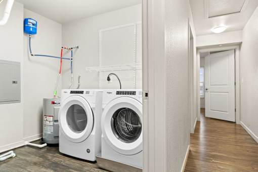 Two front load washing machines in a laundry room.