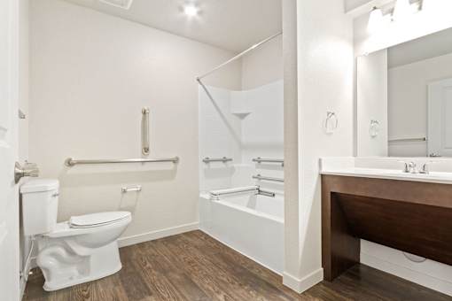 A white toilet is next to a white sink in a bathroom.
