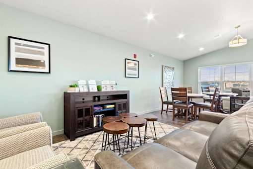 A living room with a brown leather couch and a wooden coffee table.