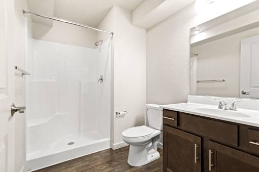 A white toilet sits next to a sink in a bathroom.