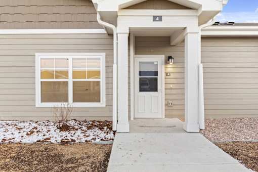 A house numbered 4 has a white door and a window.