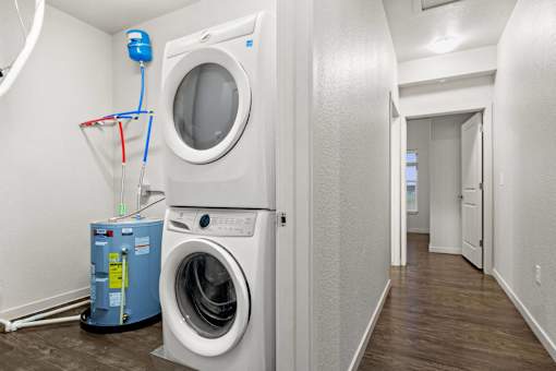 A white washing machine and dryer in a small laundry room.