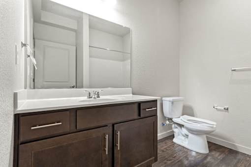 A white toilet sits next to a sink in a bathroom.