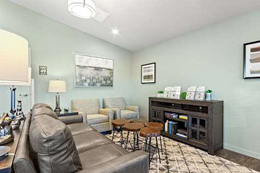A living room with a grey couch and a coffee table.