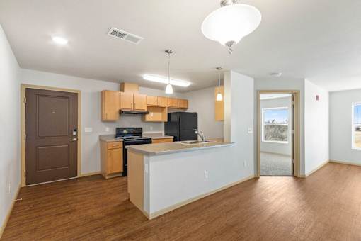 A kitchen with a white counter and wooden cabinets.