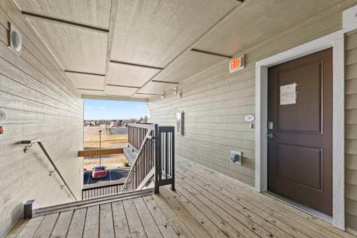 A view from the inside of a building looking out onto a balcony.