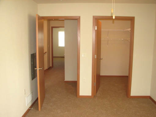 A room with a carpeted floor and a white wall.