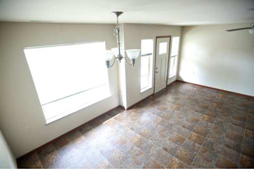 A room with a tiled floor and a chandelier.