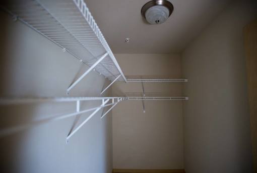 A white shelf is mounted on a wall.
