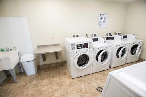 A laundry room with a white dryer and washer.