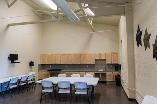 A room with a long table and chairs.