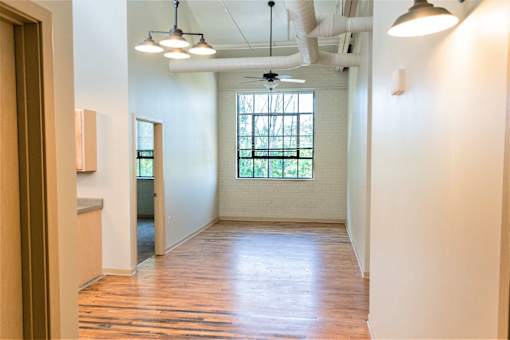 A room with a window and a ceiling fan.