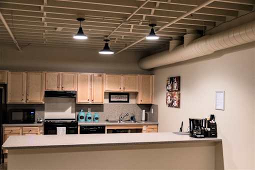A kitchen with a white counter and wooden cabinets.
