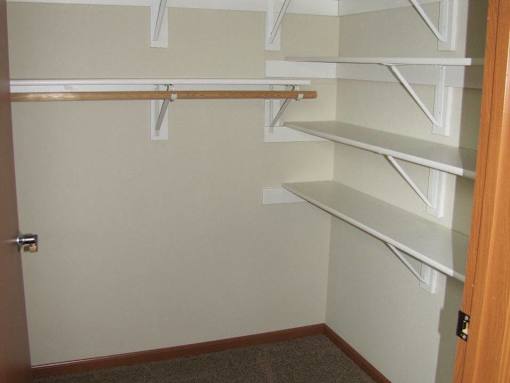 Empty white shelves in a room.