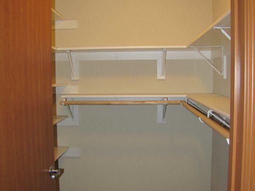 A white shelf is mounted on a wall.