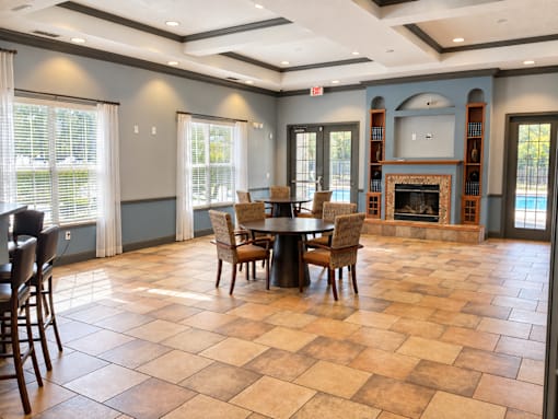 A large dining room with a fireplace and a checkered floor.