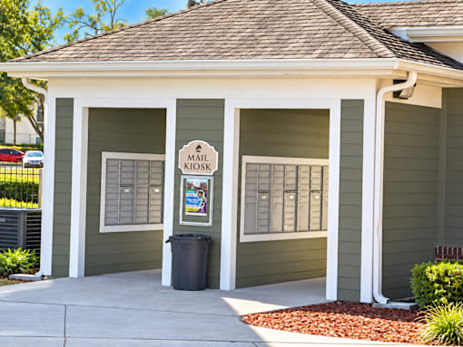 A small building with a sign that says mail kiosk.