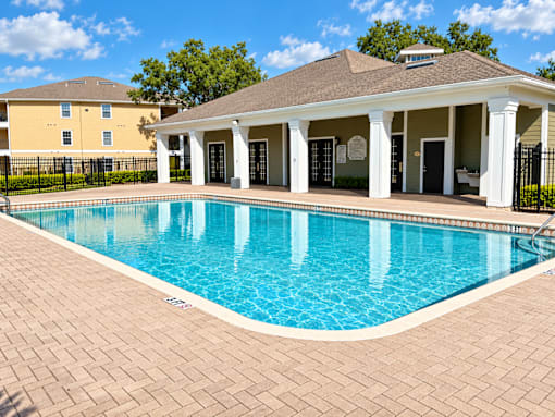A pool with a building in the background.