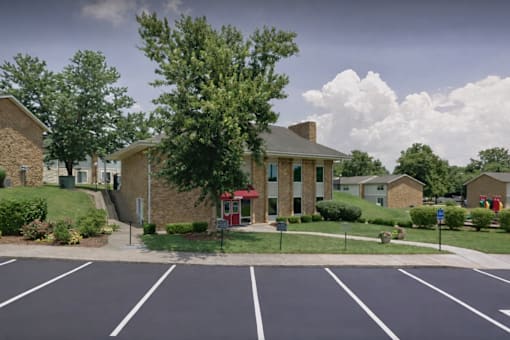 A parking lot with a building in the background.