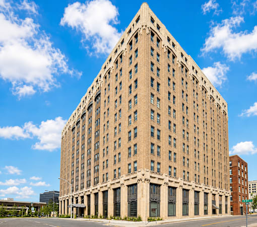 A large, beige, rectangular building with many windows and a flat roof.