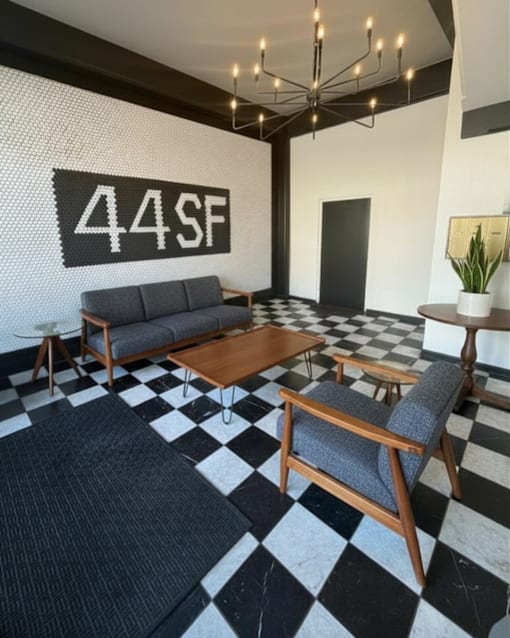 A black and white checkered floor in a room with a sofa and a coffee table.