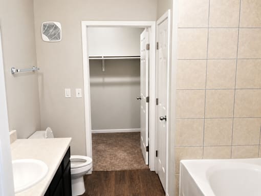 A bathroom with a toilet, sink, and bathtub.