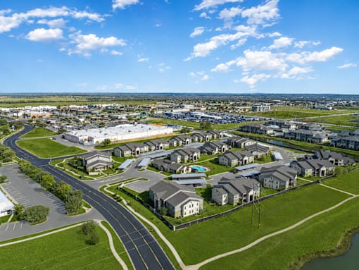 A suburban neighborhood with houses and a winding road.